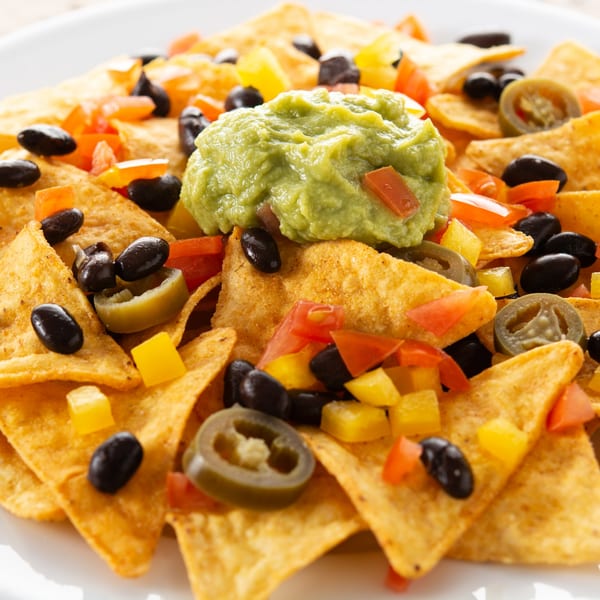 El Molino's nachos with guacamole, black beans, diced tomatoes, yellow peppers, and jalapeños.